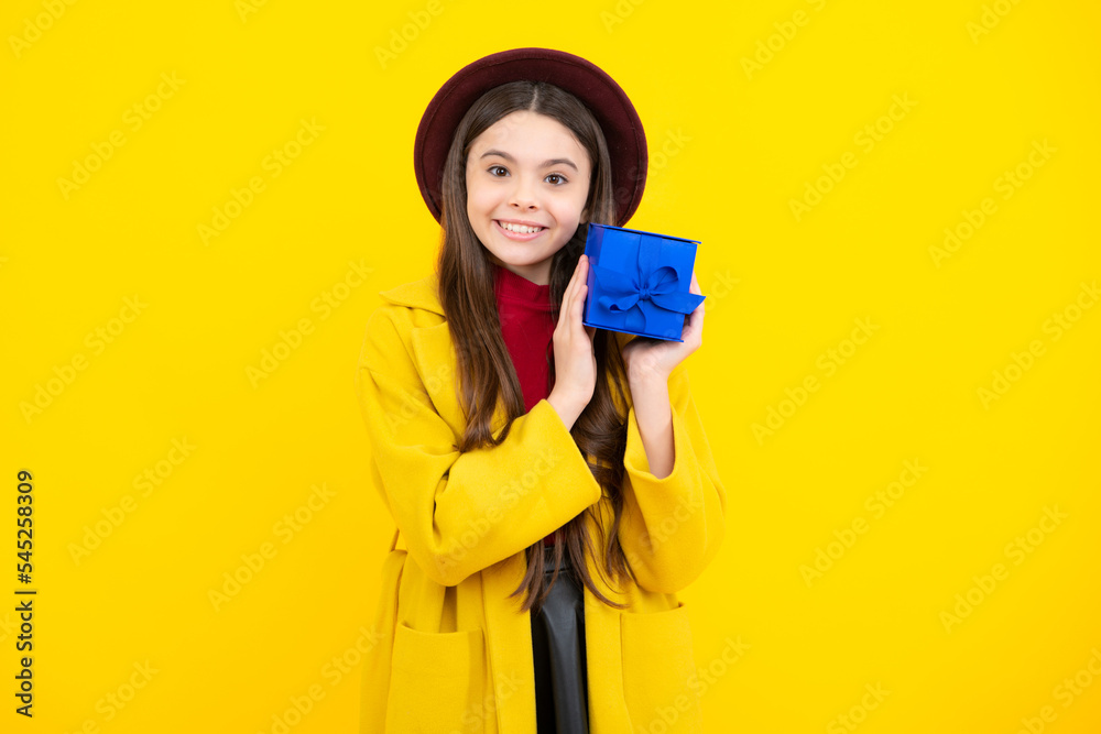 Happy teenager portrait in autumn hat and yellow coat. Autumn kids sale. Teenager child with gift box. Present for autumn holidays. Happy teenager portrait in autumn hat and yellow coat. Autumn kids sale. Teenager child with gift box. Present for autumn holidays.