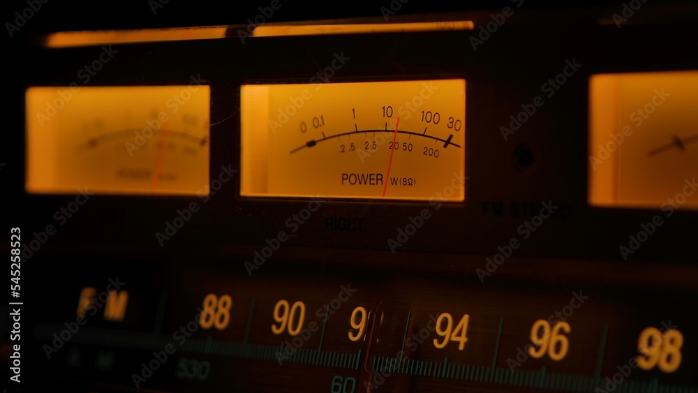 Yellow controls dashboard on an old analog radio. Close up of a scale ...