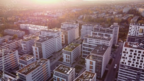 Aerial view of modern housing district in city of Cracow (Kraków Bronowice), Poland. White blocks of flats seen from drone during sunset. photo