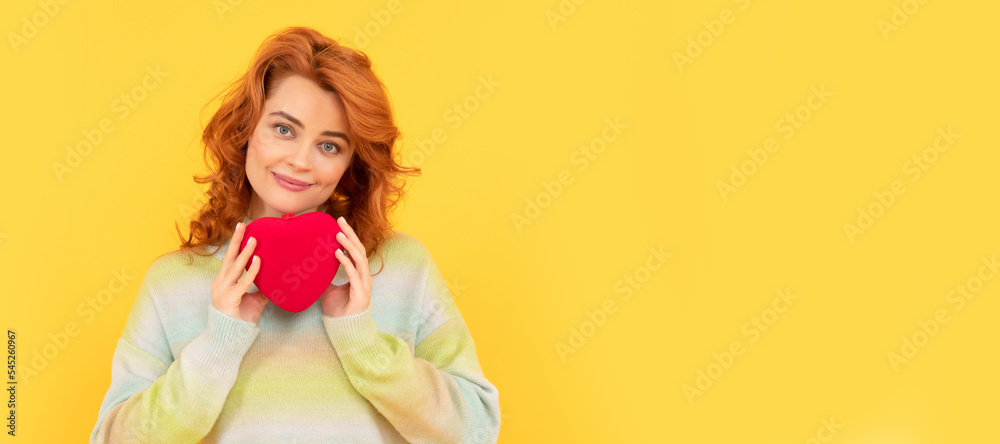 Woman isolated face portrait, banner with copy space. smiling redhead woman with red heart on yellow background. Woman isolated face portrait, banner with copy space. smiling redhead woman with red heart on yellow background.