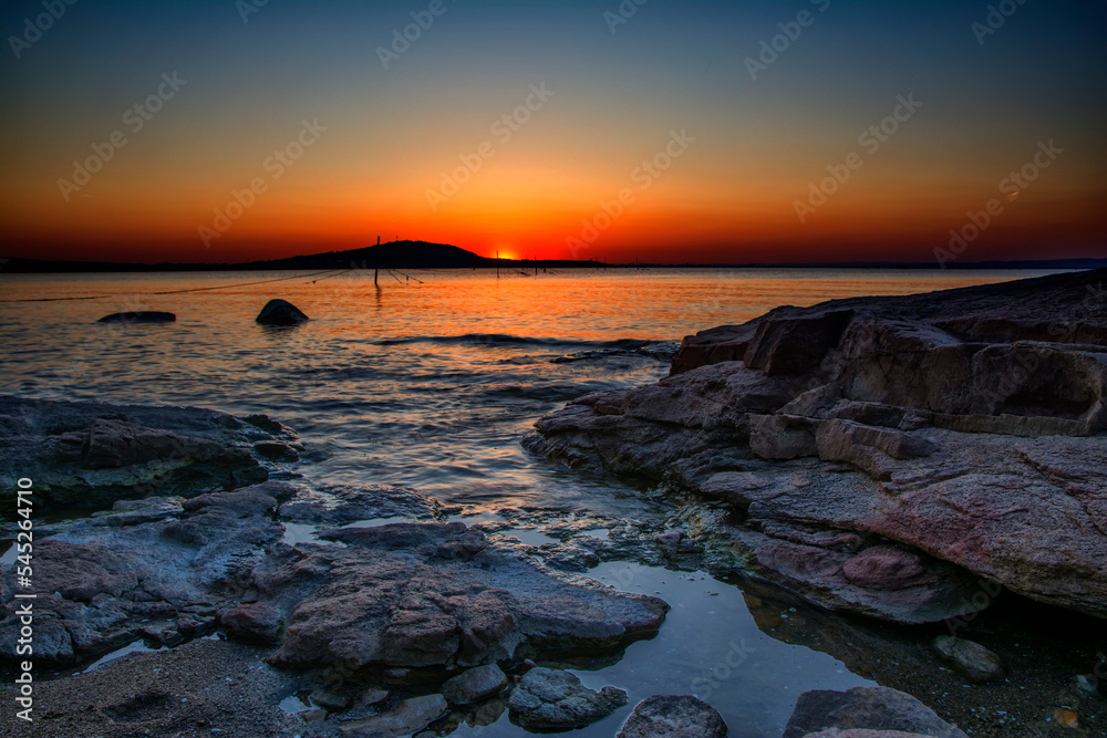 Beautiful colorful sunris at the sea with dramatic clouds and sun shining. Long Exposure of Soft and colorful sunset. Beautiful colorful sunris at the sea with dramatic clouds and sun shining. Long Exposure of Soft and colorful sunset.