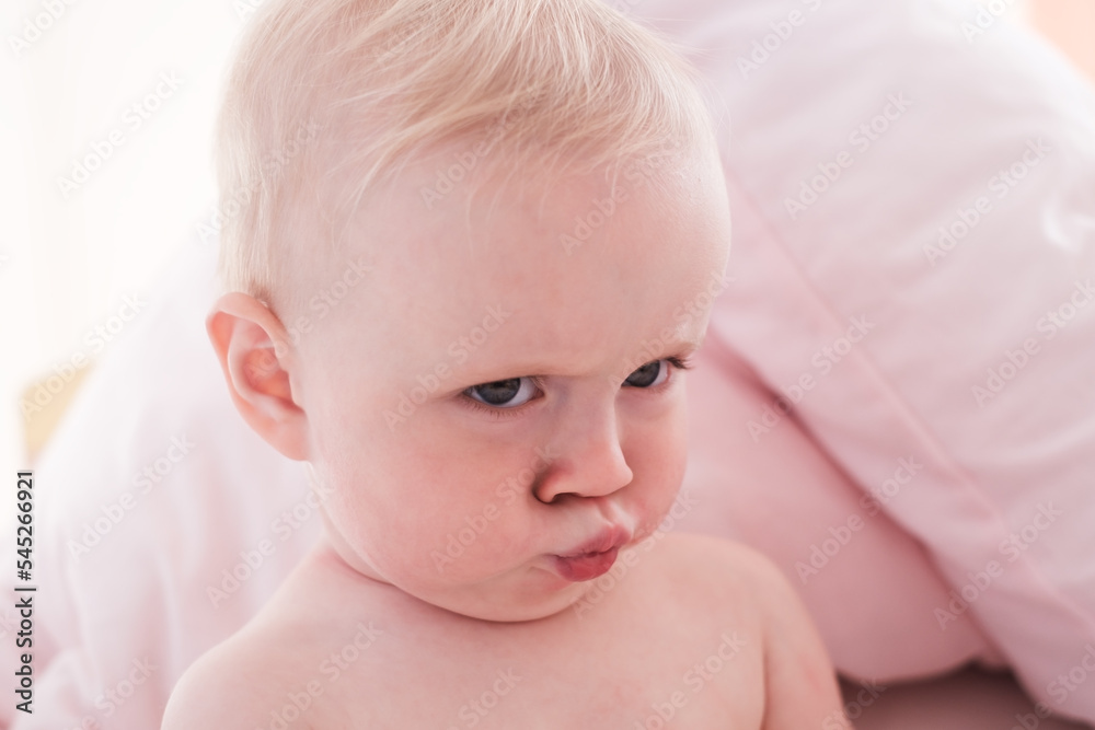 Serious caucasian baby girl eyebrow frown having bad mood Serious caucasian baby girl eyebrow frown having bad mood