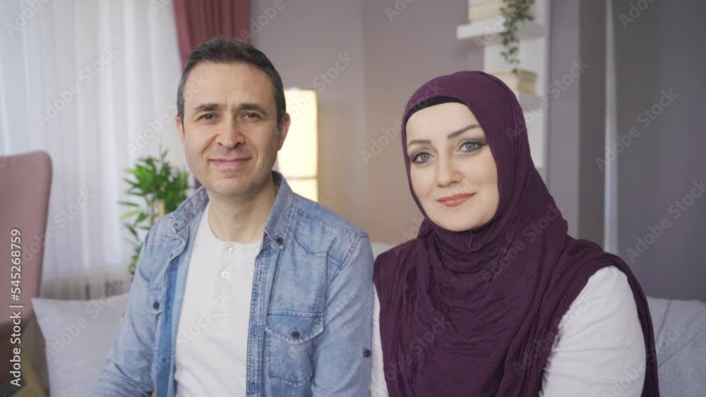 Smiling Muslim family looking at camera.
The veiled woman and her husband are smiling and looking at the camera.
Smiling Muslim family looking at camera.
The veiled woman and her husband are smiling and looking at the camera.