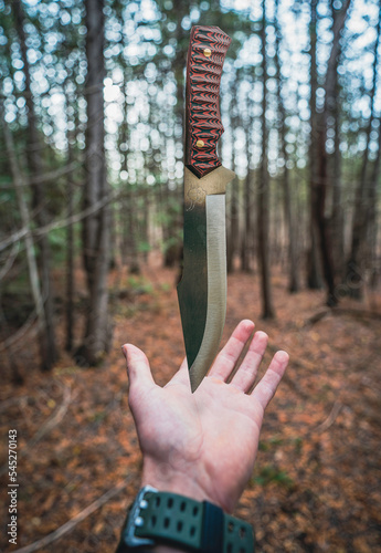 person in the forest with a knife