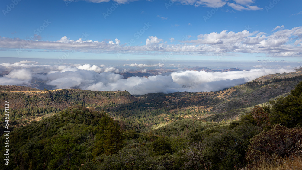 Beautiful vistas of the valleys and forests of Kings Canyon and Sequoia National Park, with low clouds and blue skies