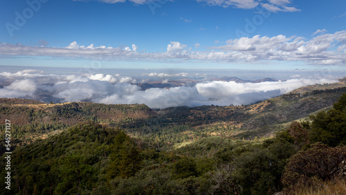Beautiful vistas of the valleys and forests of Kings Canyon and Sequoia National Park, with low clouds and blue skies