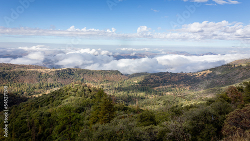 Beautiful vistas of the valleys and forests of Kings Canyon and Sequoia National Park, with low clouds and blue skies © Hulshofpictures