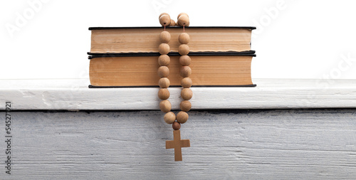 The book of Catholic and rosary beads on the wooden table photo