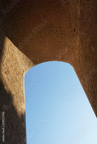 masive stony arch contruction and blue sky photo