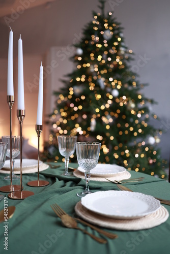 Christmas setting of the festive table in green colors