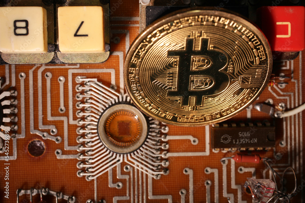 The bitcoin gold coin lies on an electronic circuit