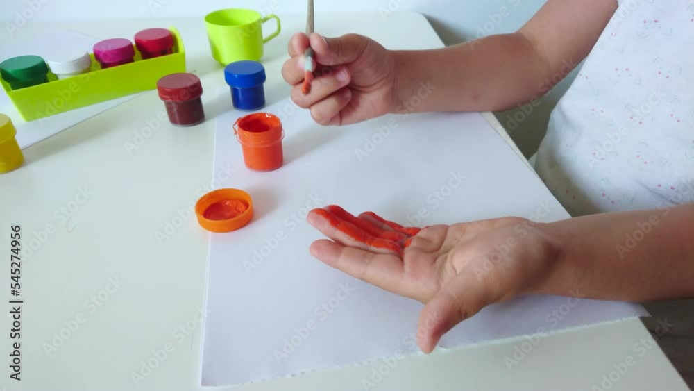 Little child draws with watercolor, concept of education in the kindergarten Little child draws with watercolor, concept of education in the kindergarten