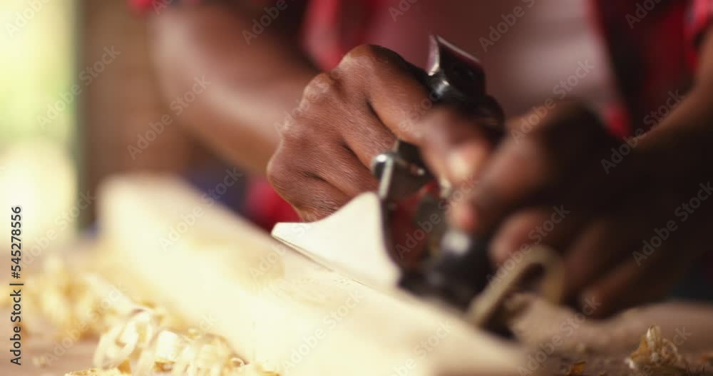 Profession, people, carpentry, woodwork - Female carpenter working with plane and wood plank at workshop Profession, people, carpentry, woodwork - Female carpenter working with plane and wood plank at workshop