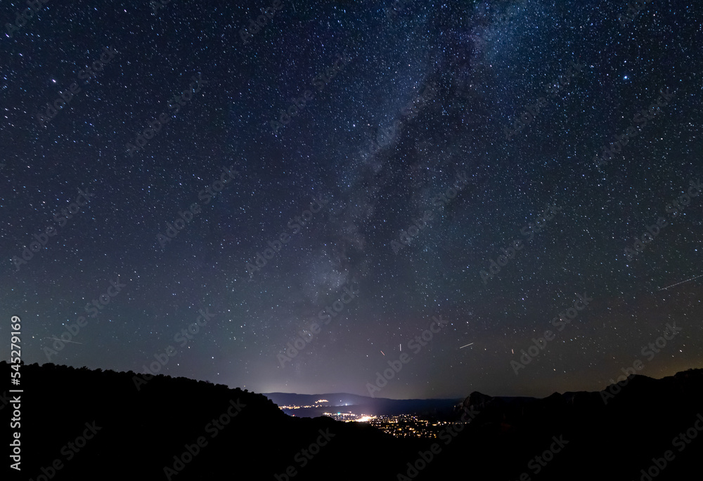 The galactic cloud of the Milky way setting over the city of Sedona, Arizona.