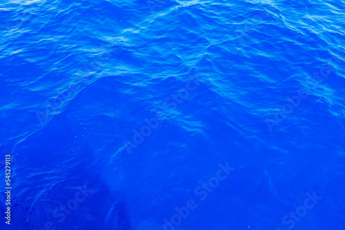 Very nice sea water background or backdrop with selective focus. Small waves of natural water surface texture.