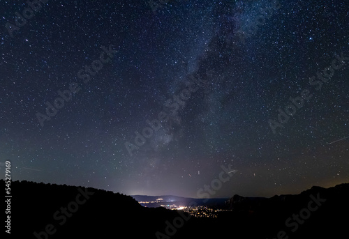 The galactic cloud of the Milky way setting over the city of Sedona  Arizona.