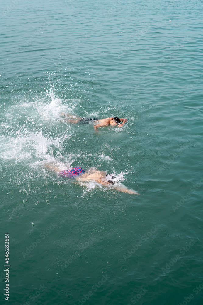 Young men swimming in the sea