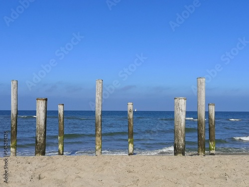 View over the Dutch Beach of Petten. Palendorp, wooden poles.