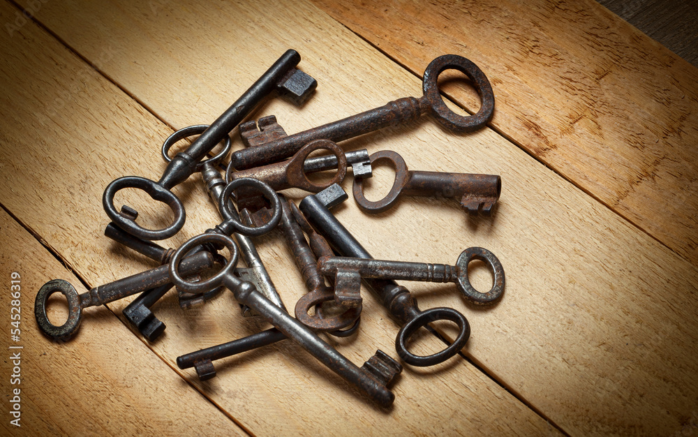 old keys on a background of wooden boards old keys on a background of wooden boards