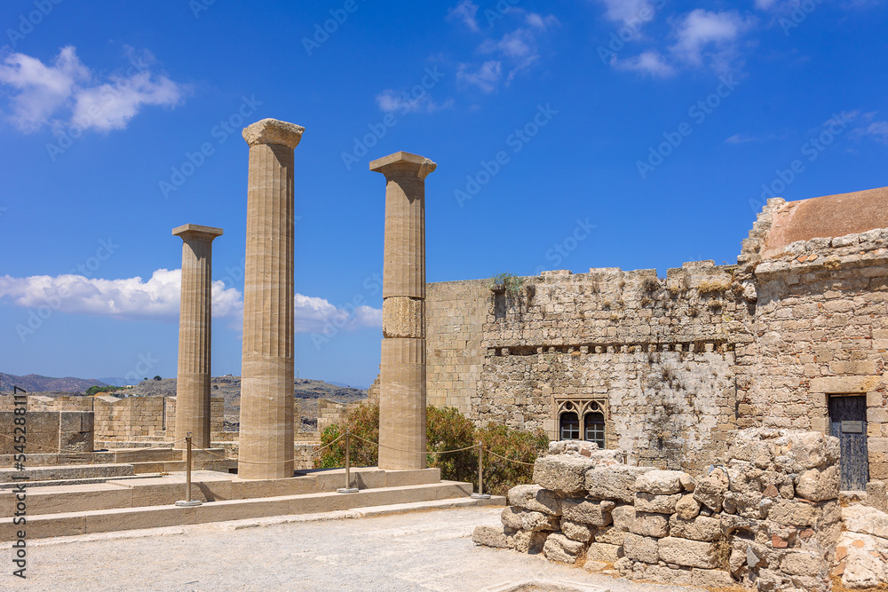 Panoramic view of ruins of ancient city of Lindos on colorful island of Rhodes, Greece. Famous tourist attraction. Ancient temple Greek architecture. High quality photo