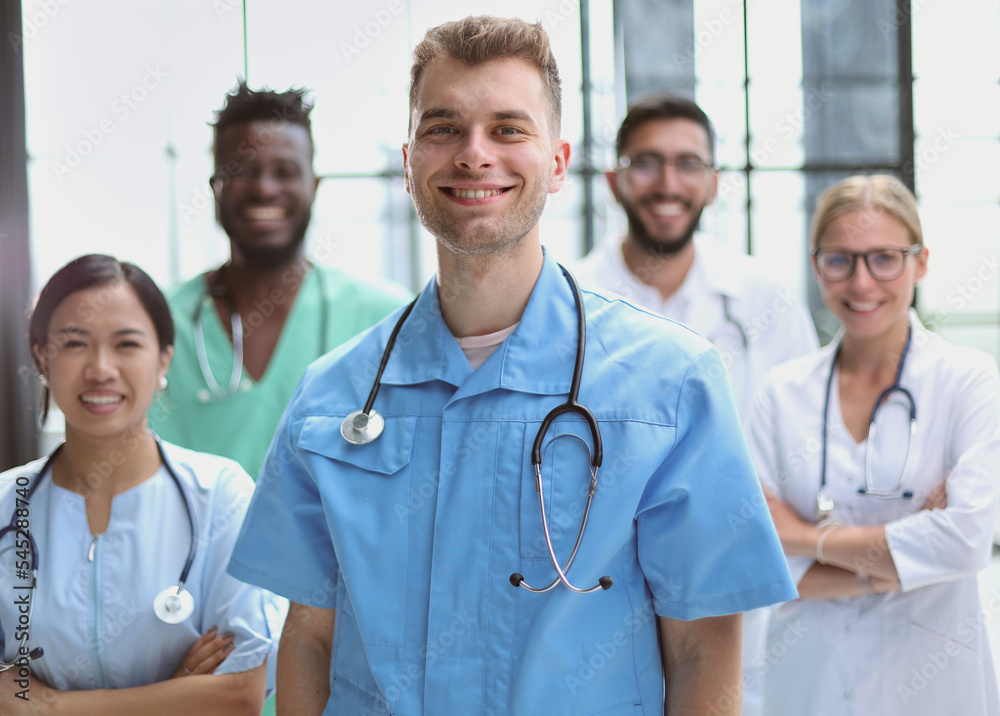 Fototapeta premium Multinational interns and professor cooperating at a hospital meeting