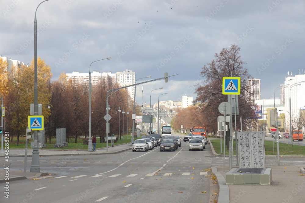 Traffic on Varshavskoe highway. Dark stormy clouds. Contrasting sky. Dirty cars on the road. Moscow, October 2022.