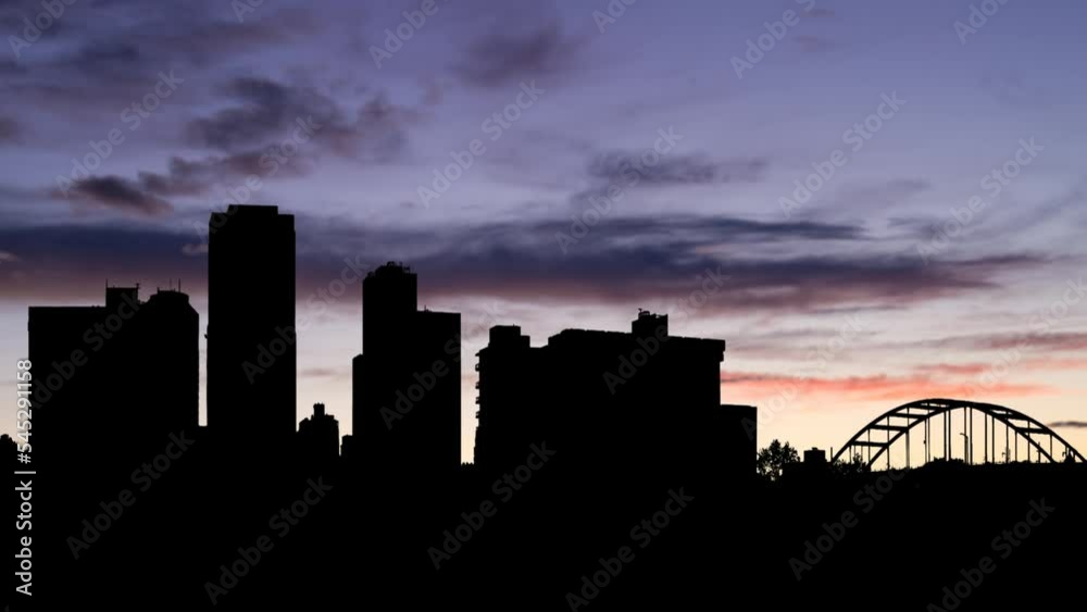 Little Rock Skyline, Time Lapse at Twilight with Colorful Clouds and Dark Silhouette of Skyscrapers and Bridge, Arkansas, USA Little Rock Skyline, Time Lapse at Twilight with Colorful Clouds and Dark Silhouette of Skyscrapers and Bridge, Arkansas, USA