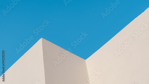 Minimalistic photo of building with white color and blue sky in the background