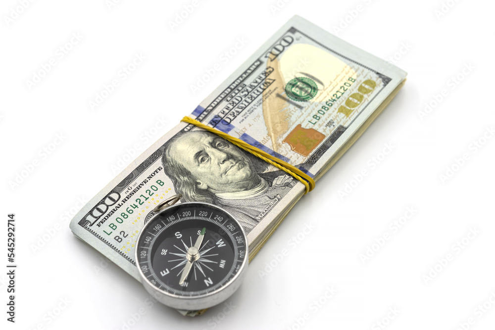 Pack of one hundred dollar bills and compass isolated on white background