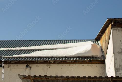 Snow on roof. Roof of building in winter. Architectural details.