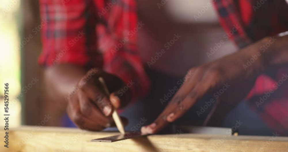 Close up view of hardworking focused professional carpenter woman holding ruler and pencil Close up view of hardworking focused professional carpenter woman holding ruler and pencil