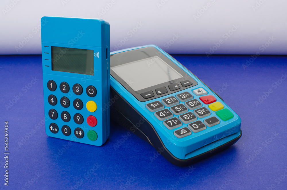 Credit card payment machine.POS terminal and bank card.Concept of payments, money, purchases and credit card installment. Blue credit card machine with numeric keys and display screen. Brazil credit Credit card payment machine.POS terminal and bank card.Concept of payments, money, purchases and credit card installment. Blue credit card machine with numeric keys and display screen. Brazil credit