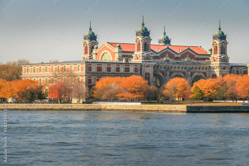 Ellis Island skyline from hudson river at golden autumn in New York , USA