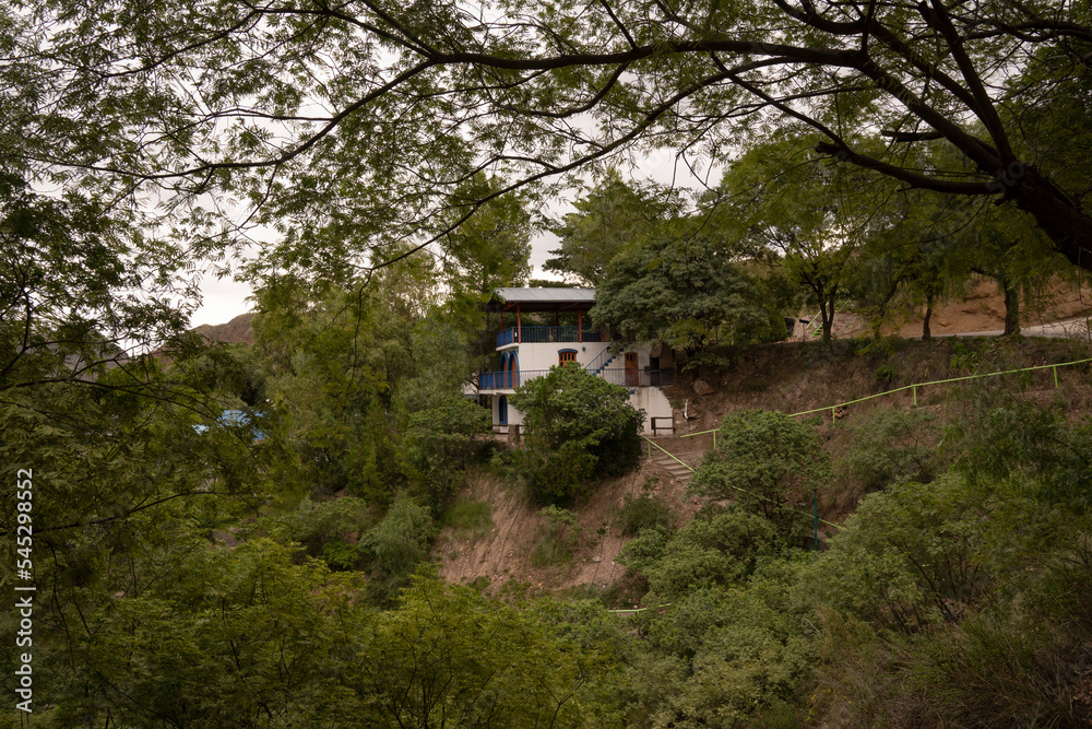 View of a house built in the mountain forest. View of a house built in the mountain forest.