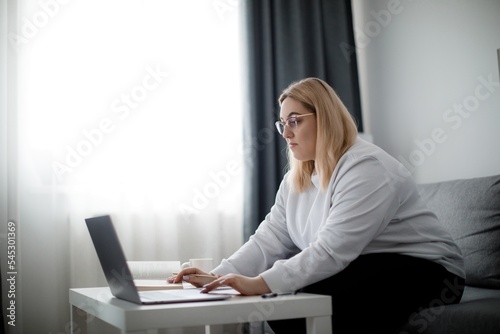 Plus size woman with laptop