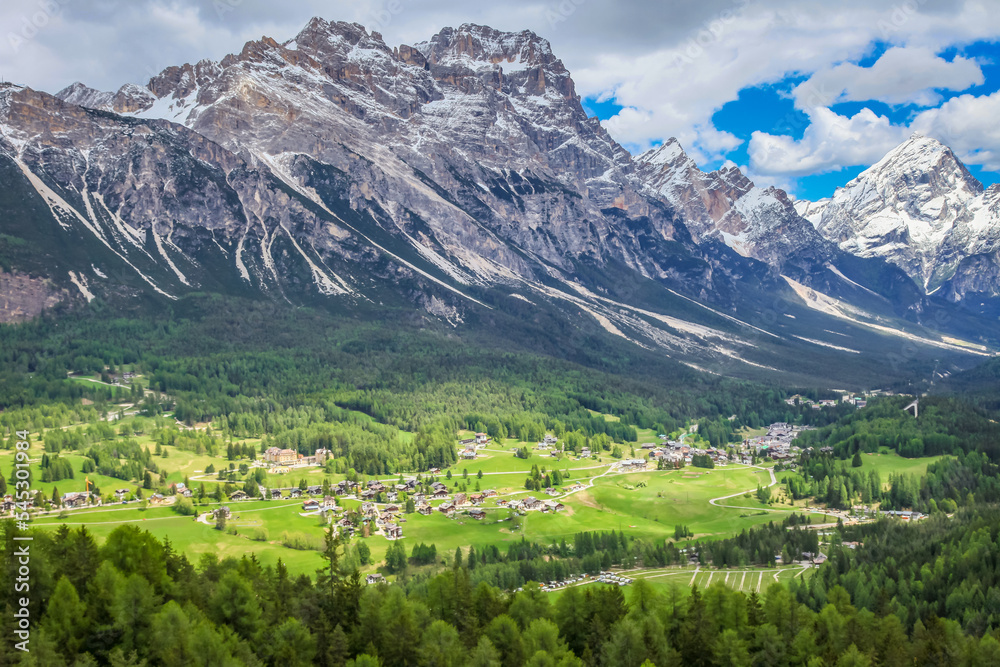 Cortina D Ampezzo cityscape and alpine meadows with Dolomites alps, Italy