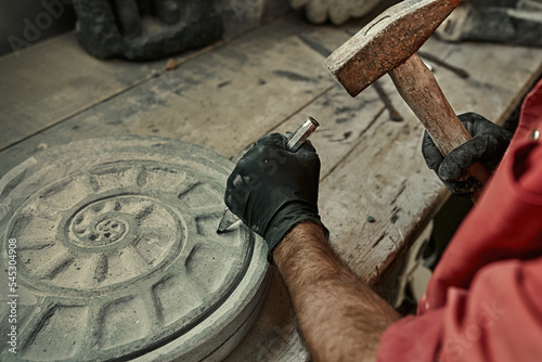 The craftsman works with stone with different tools. atmospheric photo. Sculpture making, handmade