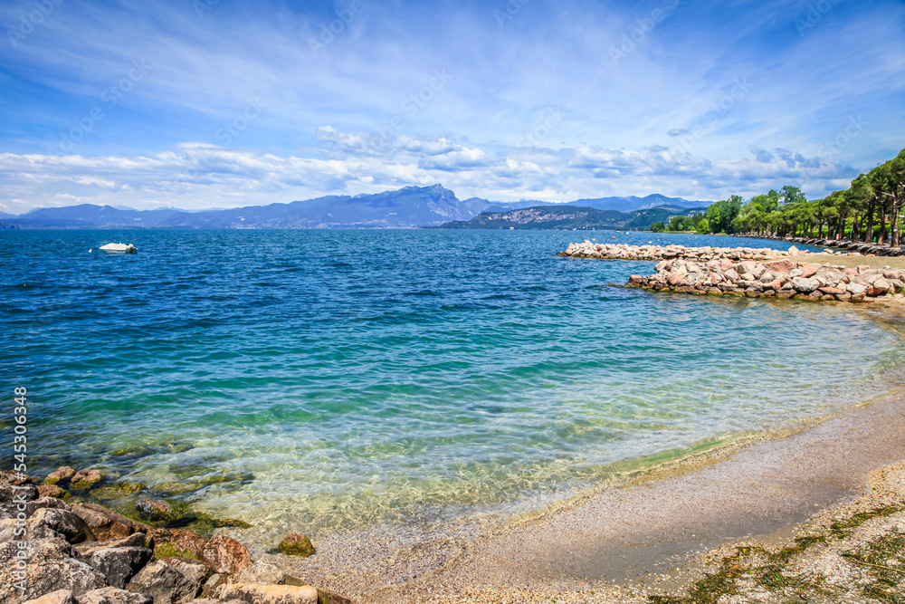 Idyllic lake Garda coastline in Lazise with boat, Northern Italy