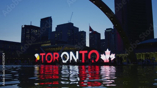 Toronto sign in Nathan Phillips Square, Toronto, Canada, at dusk photo