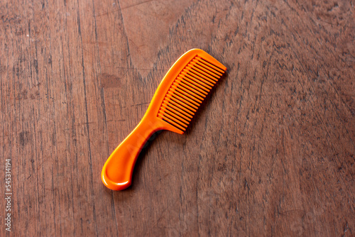 yellow comb hair on wooden floor