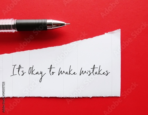 On red background, pencil writing on torn paper - It's Okay to Make Mistakes -  concept of positive self worth, seeing mistakes as part of  learning process of life, not mean the end of the world photo