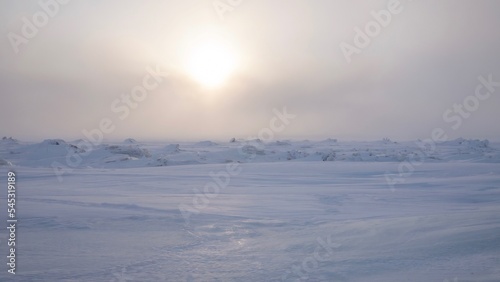 An Arctic winter landscape as the sun sets over the frozen tundra, near Churchill, Manitoba, Canada. © Cheryl Ramalho