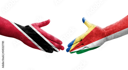 Handshake between Seychelles and Trinidad Tobago flags painted on hands, isolated transparent image.