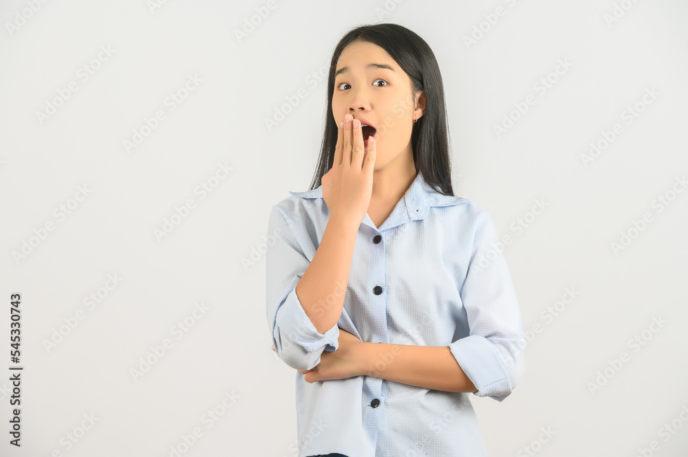 Portrait of Excited young asian woman in blue shirt hand cover mouth isolated on white background Portrait of Excited young asian woman in blue shirt hand cover mouth isolated on white background