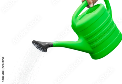 Watering can with green grass photo