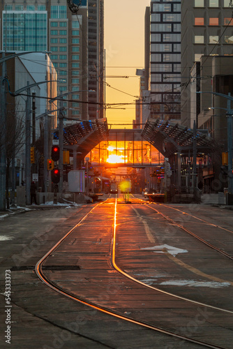 Sunset over low rapid transit tracks (C-Train) in downtown Calgary, Alberta