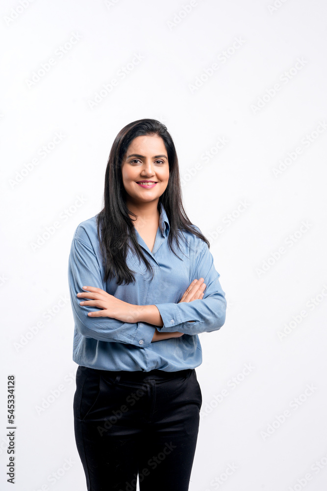 Young indian businesswoman or employee standing on white background. Young indian businesswoman or employee standing on white background.