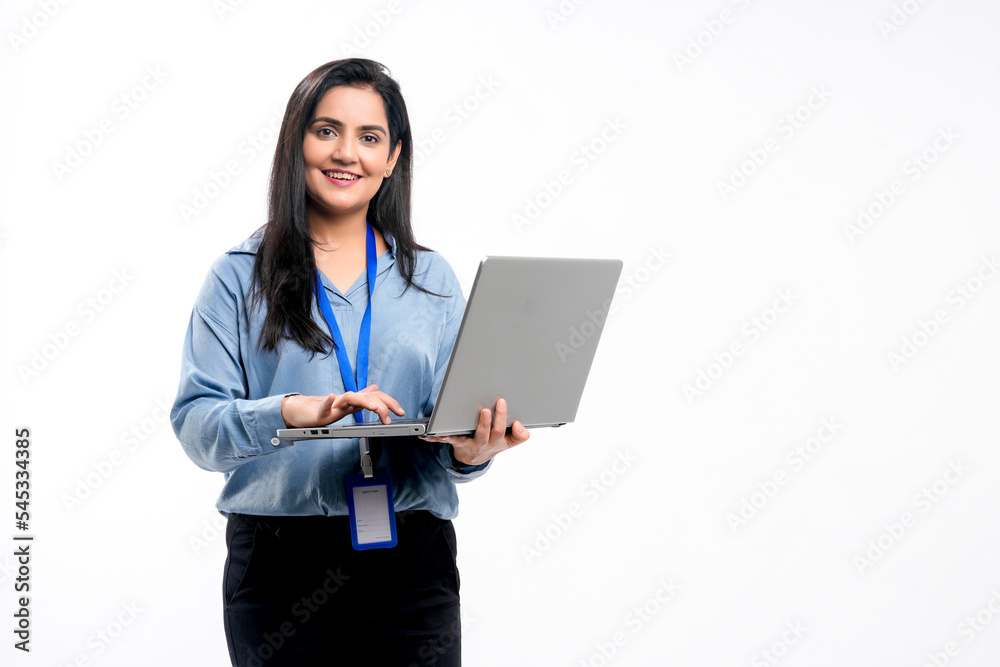 Indian businesswoman or employee using laptop on white background. Indian businesswoman or employee using laptop on white background.