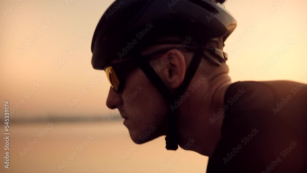 Cyclist fitness riding on road bike ready for triathlon race Cyclist fitness riding on road bike ready for triathlon race