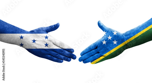 Handshake between Solomon Islands and Honduras flags painted on hands, isolated transparent image.